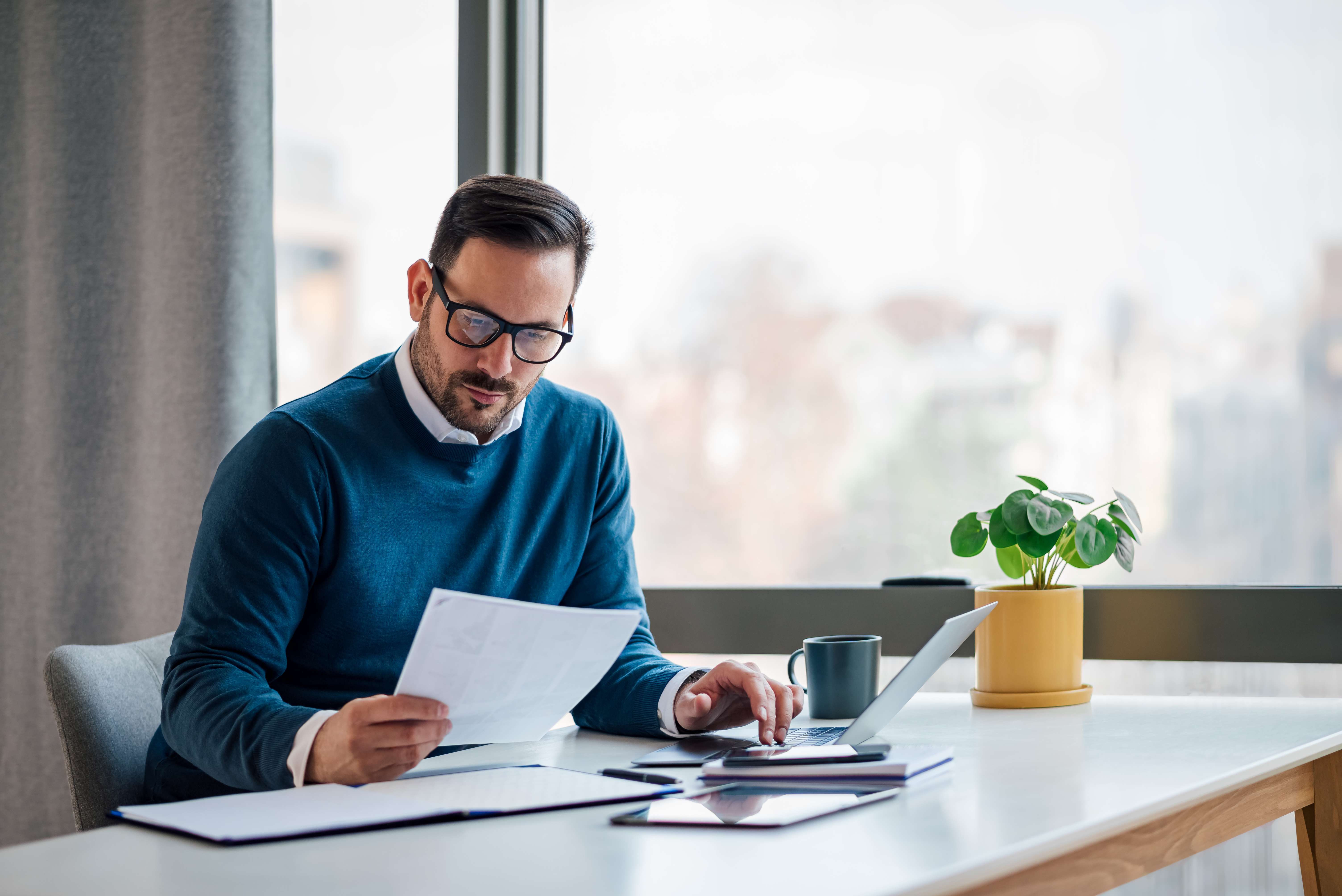 A man reading a document in your table