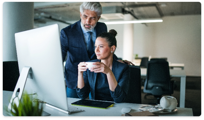 A man and a woman looking at a screen